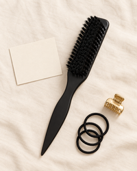 SwishSleek Smoothing Brush flat lay with hair ties