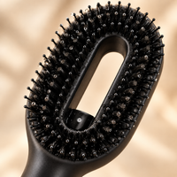 Close-up of the boar and nylon bristles and mist nozzle